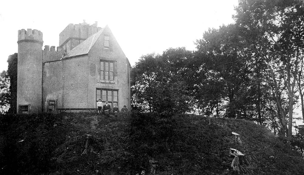 “Pirate Byrne’s Folly,” built atop Dún Dealgan in 1780, was rebuilt in 1850 by T. Vesey Dawson, seen here with his family. Today only the rectangular tower in the back remains standing. The Dawson Home