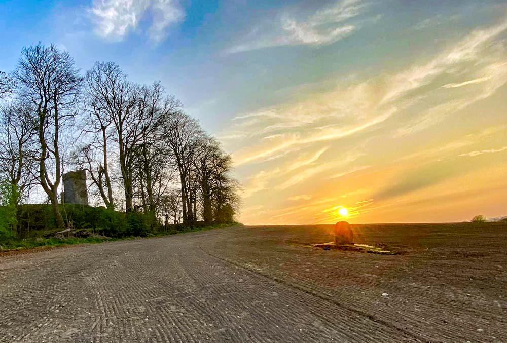 The sun sets over the standing stone at the base of Dún Dealgan. In local folklore, it marks the spot of Cúchulainn's birth.(Pádraig O'Cumascaigh) Standing Stone
